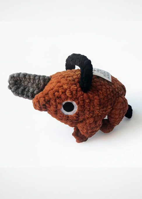 pochita from chainsaw man as lifesized amigurumi replica standing one foot tall made with super soft brown chenille yarn, grey chenille yarn for the chainsaw and black chenille for the handle stuffed with wire for rigidity. Sturdy Handmade Anime inspired plush.