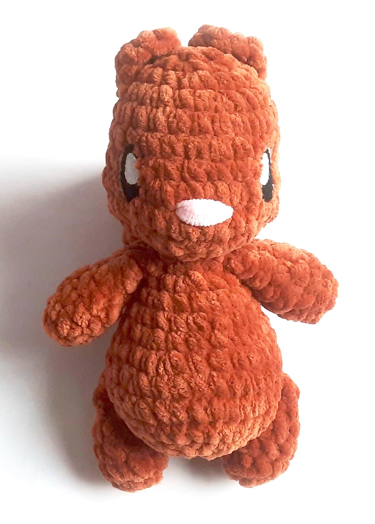Crocheted red squirrel plush toy on a white background