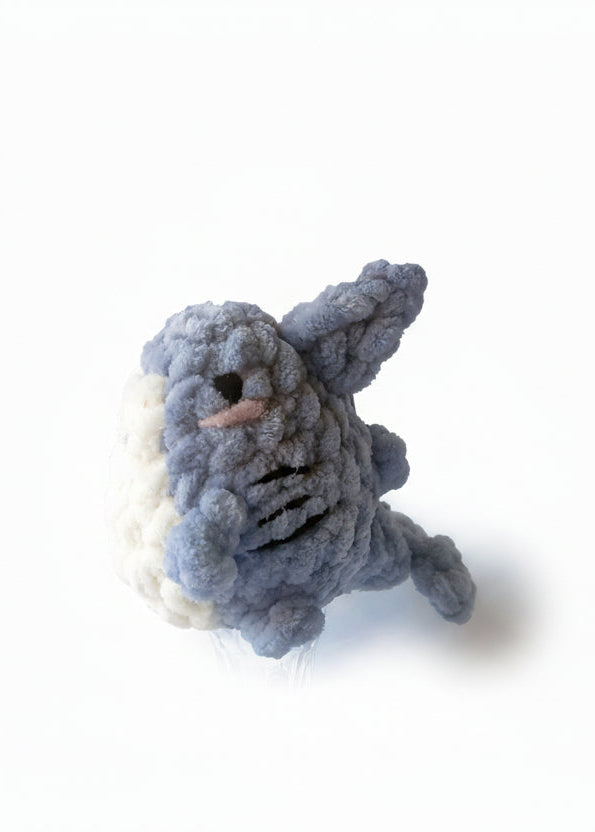 Small gray plush shark toy on a white background