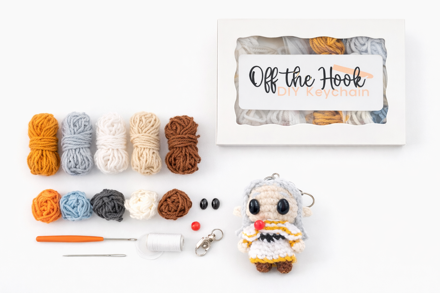 Complete Friren crochet kit showing yarn, crochet hook, stuffing, handmade accessories, and crochet pattern box the kit is sold in.