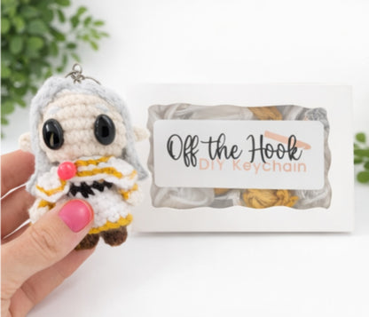 Handmade Friren chibi crochet keychain held in hand, created using complete crochet kit