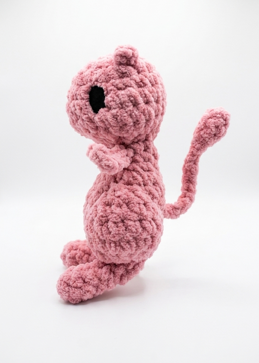 Pink crochet mew toy on a white background
