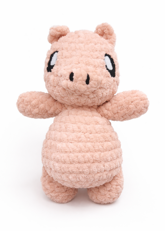 Plush toy resembling a small pink pig on a white background